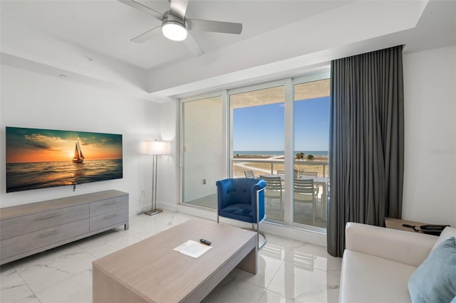 living room featuring ceiling fan, a healthy amount of sunlight, and floor to ceiling windows