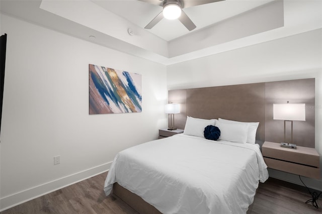 bedroom featuring ceiling fan and dark wood-type flooring