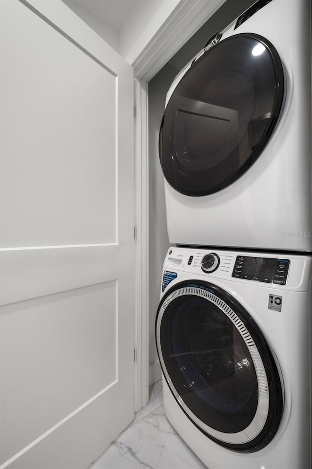 washroom featuring stacked washer / dryer