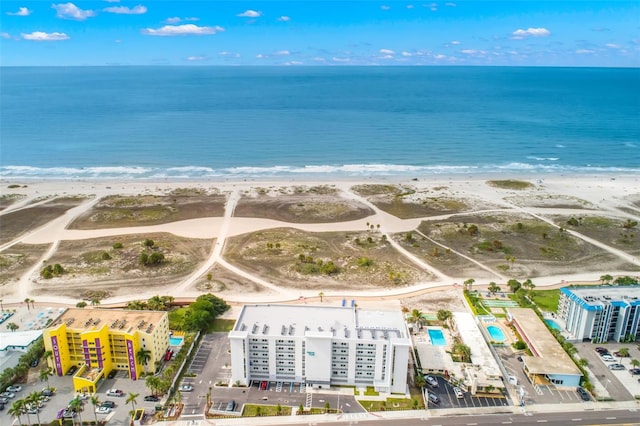 drone / aerial view featuring a water view and a view of the beach