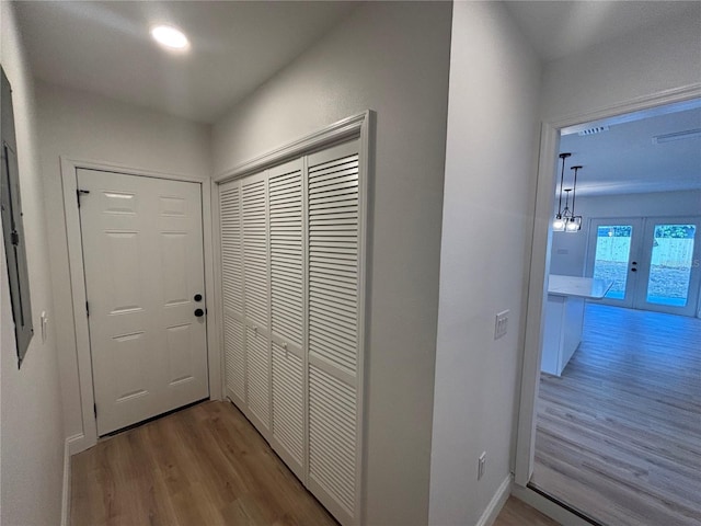 corridor featuring french doors and light wood-type flooring