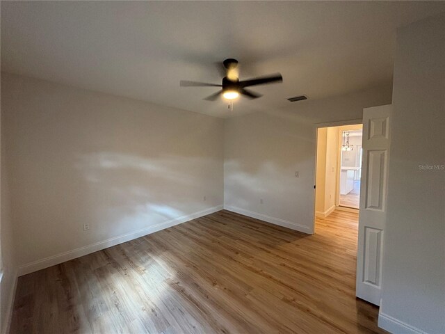 spare room featuring ceiling fan and light wood-type flooring