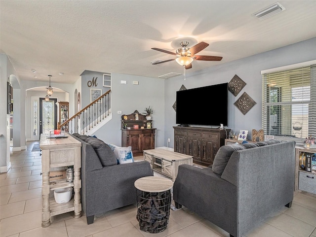 living room with a healthy amount of sunlight and light tile patterned floors