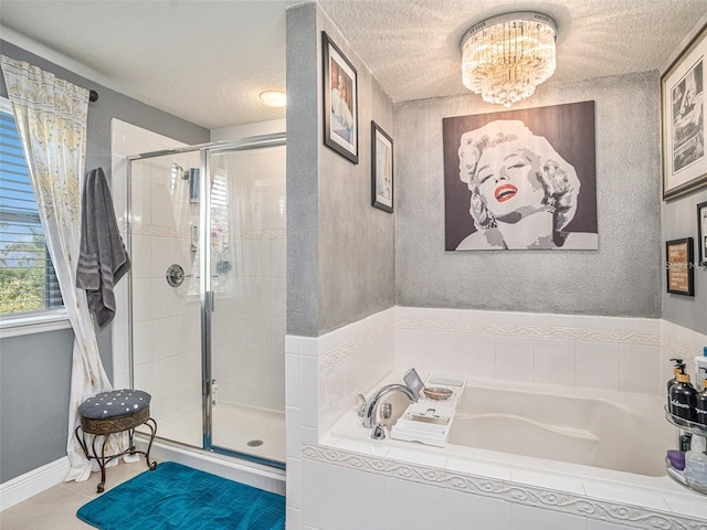 bathroom featuring a textured ceiling, shower with separate bathtub, and a notable chandelier