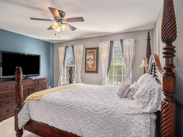 bedroom featuring multiple windows, a textured ceiling, and ceiling fan