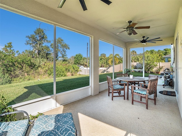 sunroom featuring ceiling fan