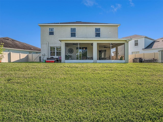 back of house with a yard and ceiling fan