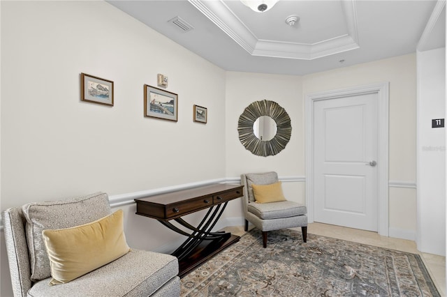 living area featuring a raised ceiling and crown molding