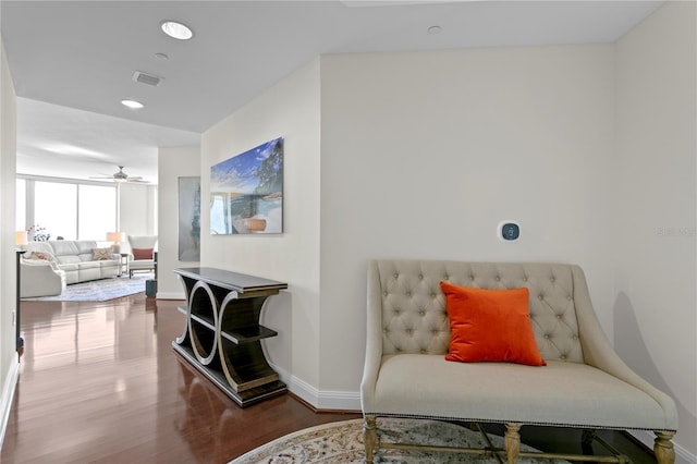 living area with ceiling fan and wood-type flooring