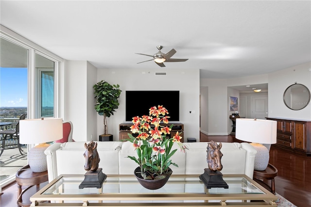 living room featuring ceiling fan and hardwood / wood-style floors