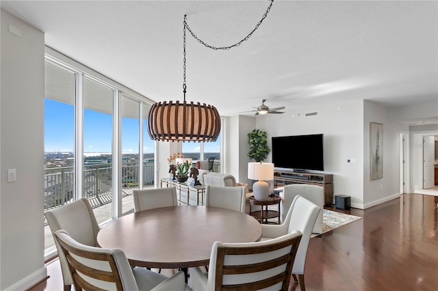 dining space with ceiling fan, dark hardwood / wood-style flooring, and a textured ceiling