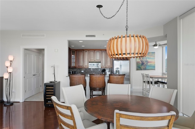 dining space featuring ceiling fan and dark hardwood / wood-style floors