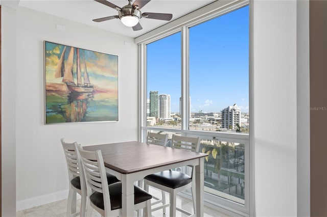 tiled dining room with plenty of natural light and ceiling fan