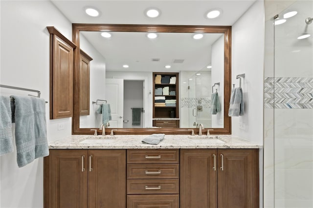 bathroom featuring vanity and a shower with door