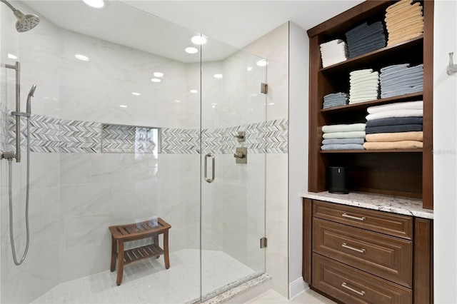 bathroom featuring a shower with shower door