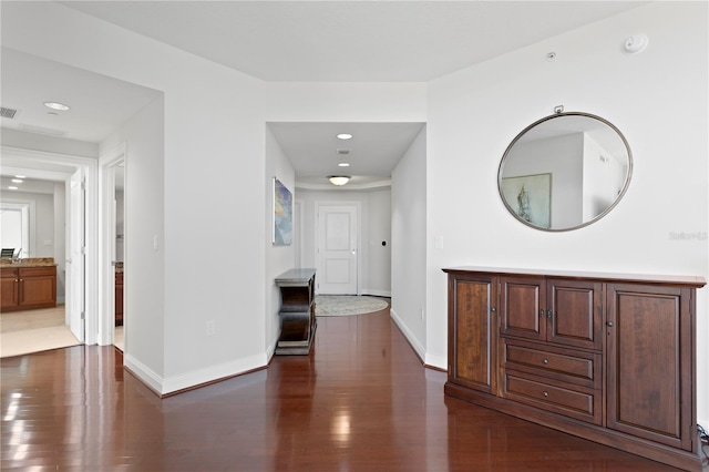 corridor with dark hardwood / wood-style flooring