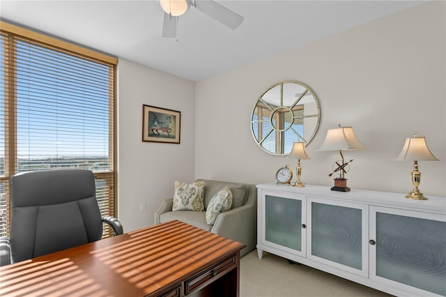 office space with light carpet and ceiling fan