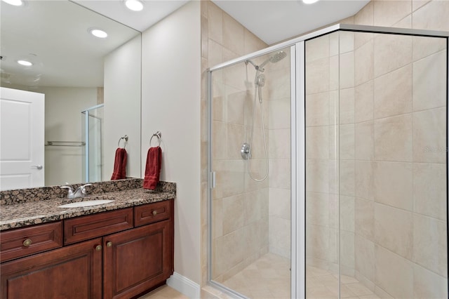 bathroom featuring vanity and an enclosed shower