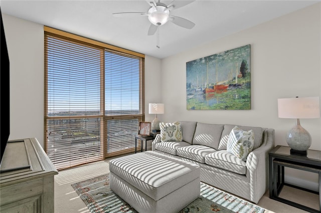 living room featuring ceiling fan, carpet floors, and a healthy amount of sunlight