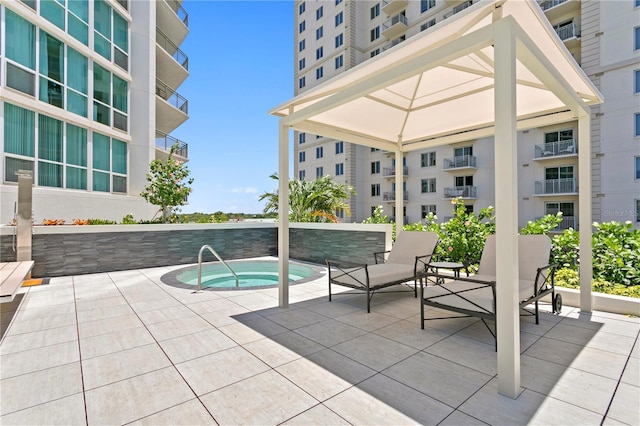 view of pool with a patio and a hot tub