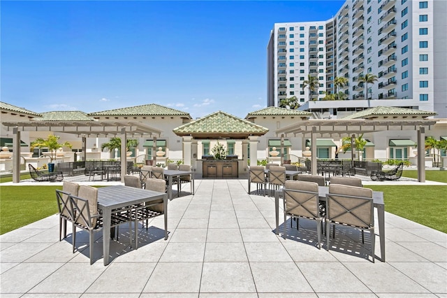 view of home's community featuring exterior bar, a pergola, and a patio area