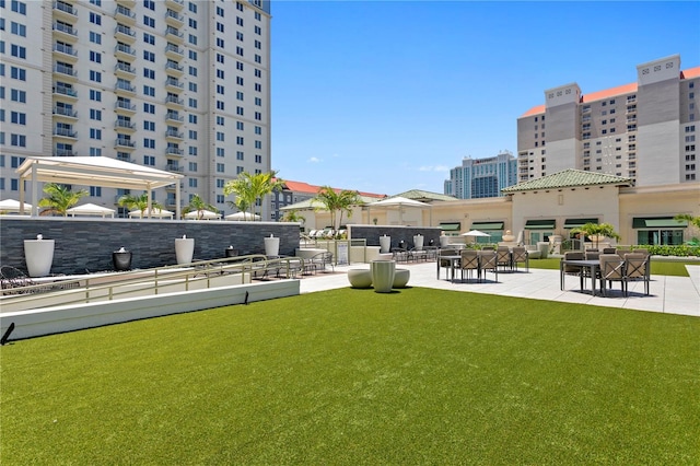 view of community featuring a patio area and a yard