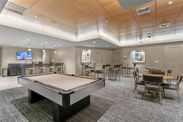 recreation room with a raised ceiling, carpet floors, indoor bar, and billiards