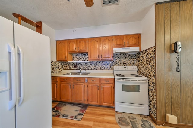 kitchen with ceiling fan, sink, tasteful backsplash, light hardwood / wood-style flooring, and white appliances