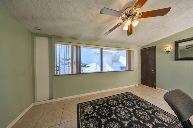 interior space with a textured ceiling and ceiling fan