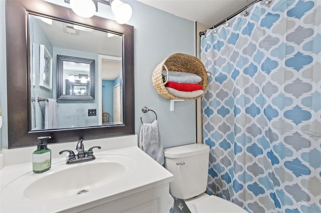 bathroom featuring vanity and toilet