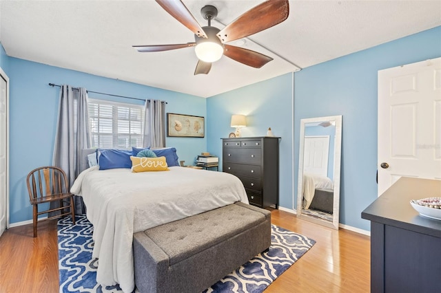 bedroom with hardwood / wood-style floors and ceiling fan