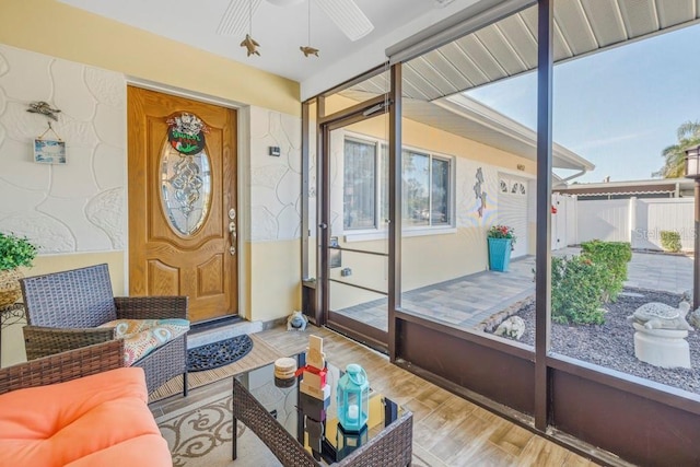 sunroom featuring ceiling fan and a healthy amount of sunlight