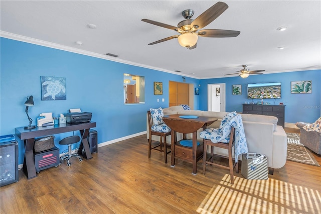 dining room with ceiling fan, hardwood / wood-style floors, and ornamental molding