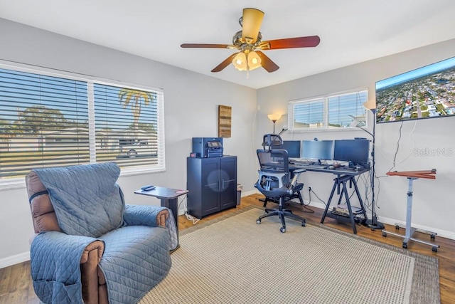 office area with ceiling fan and hardwood / wood-style floors