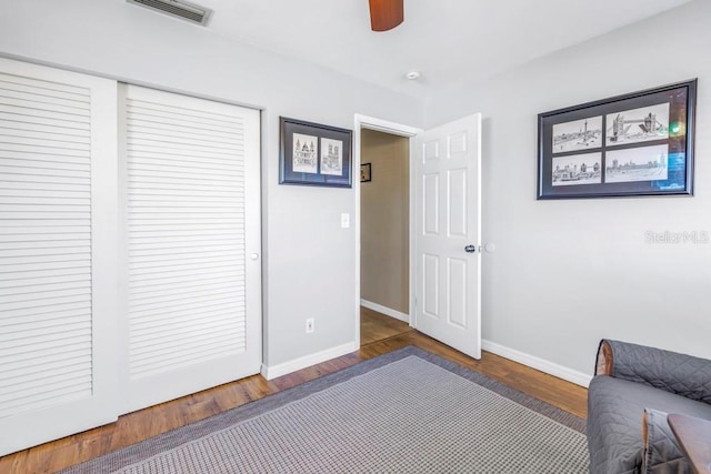 bedroom with ceiling fan and dark hardwood / wood-style flooring