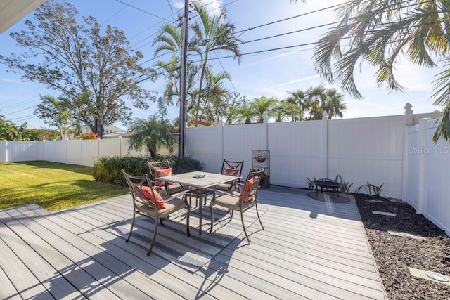 wooden terrace with a yard