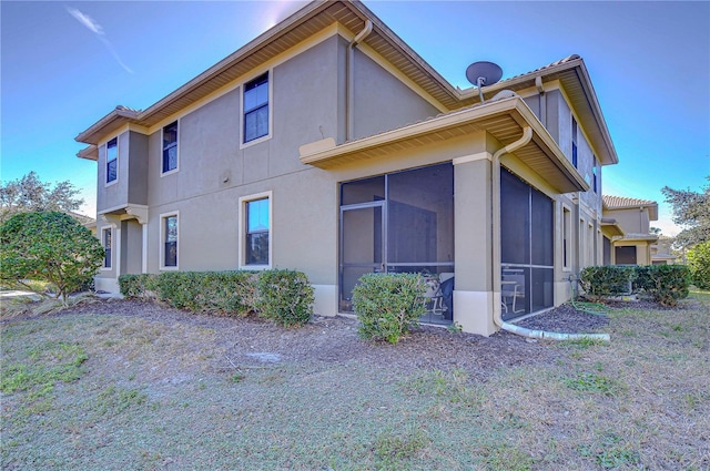 view of side of home featuring a sunroom