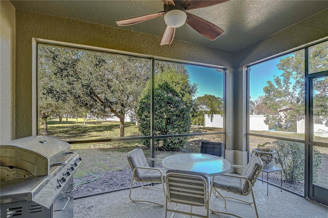 sunroom / solarium featuring ceiling fan