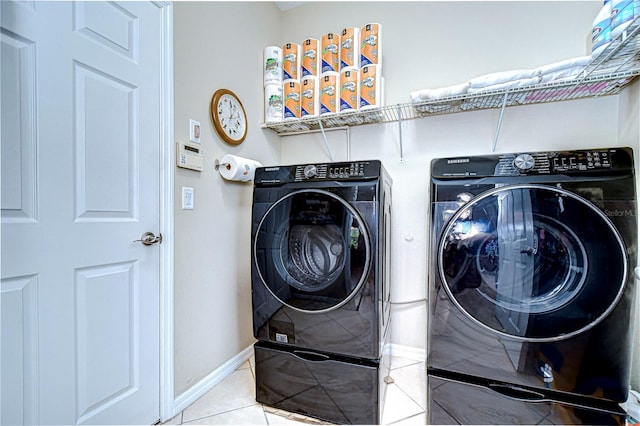 washroom featuring tile patterned flooring and washing machine and dryer