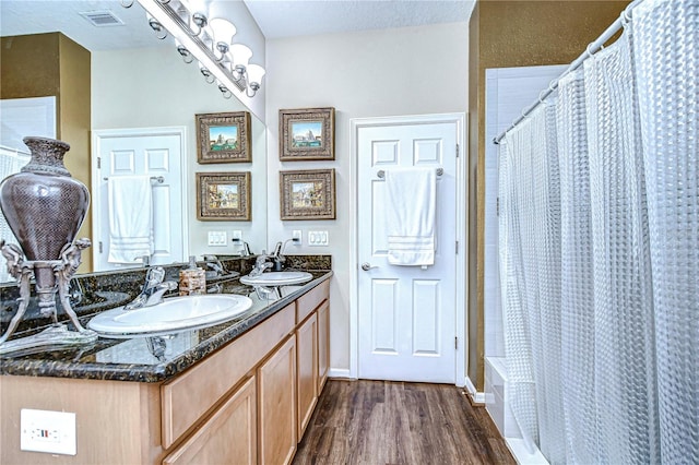 bathroom featuring hardwood / wood-style flooring, vanity, and a shower with shower curtain