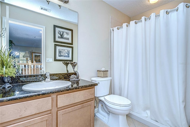 bathroom featuring curtained shower, tile patterned floors, a textured ceiling, toilet, and vanity