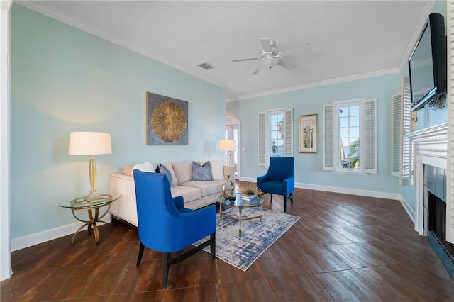 living room with dark hardwood / wood-style floors, ceiling fan, and ornamental molding