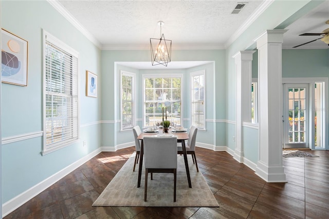 dining area with decorative columns, crown molding, and a textured ceiling