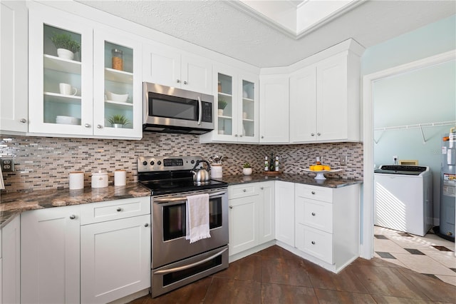 kitchen featuring backsplash, washer / clothes dryer, white cabinetry, and appliances with stainless steel finishes