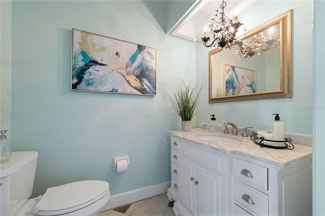 bathroom featuring toilet, vanity, tile patterned floors, and a notable chandelier