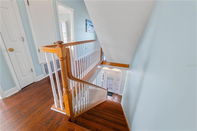 staircase with wood-type flooring