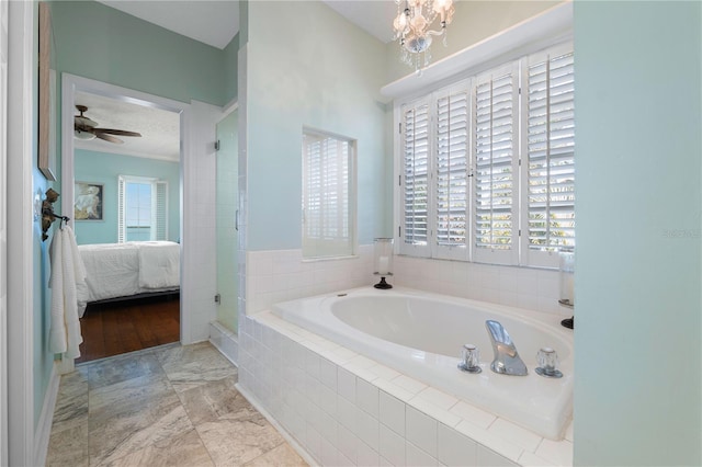 bathroom with ceiling fan with notable chandelier, a healthy amount of sunlight, crown molding, and independent shower and bath