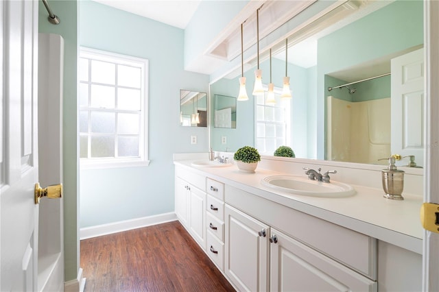 bathroom featuring vanity, wood-type flooring, and walk in shower