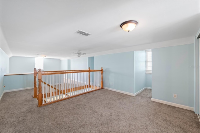 carpeted empty room featuring ceiling fan