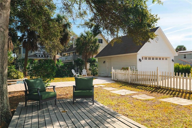 deck with a garage and an outbuilding